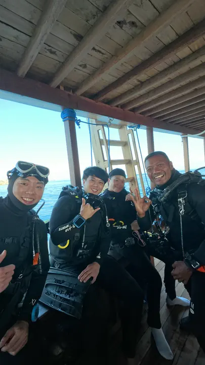Dive team smiling on board