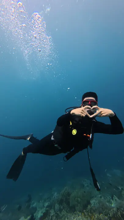 Diver making a heart sign underwater