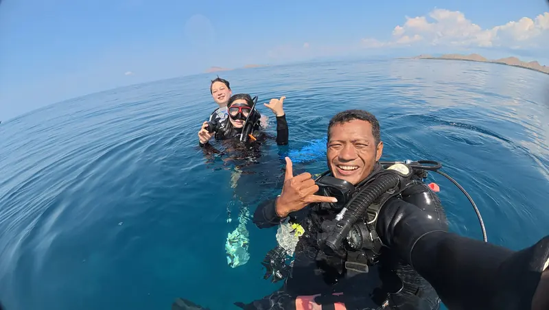 Divers smiling at the surface in Komodo after a dive